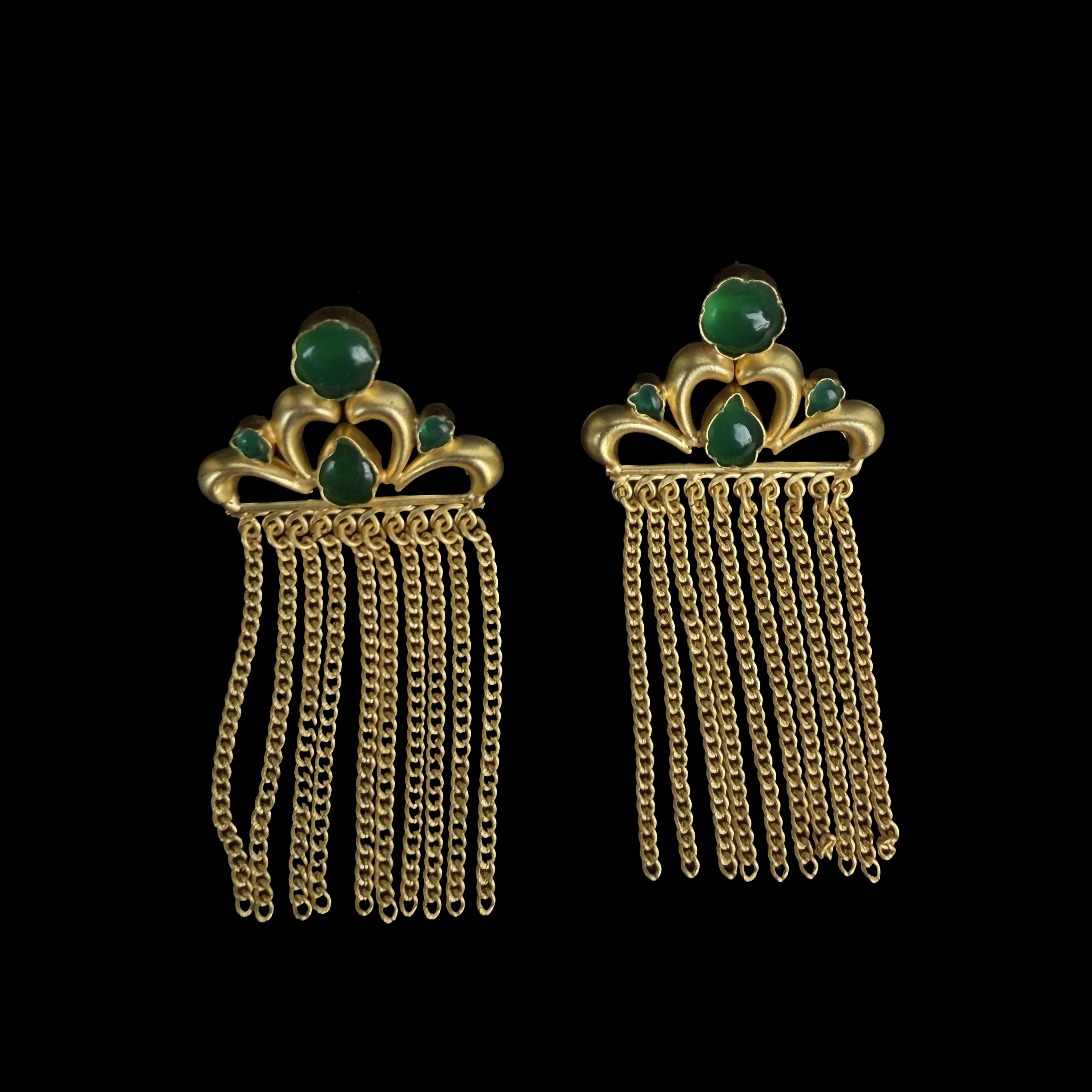 Exuding a regal aura, these earrings showcase a crown-like gold motif adorned with deep blue gemstones and cascading gold chains. The intricate detailing adds to their luxurious appeal.