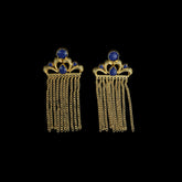Exuding a regal aura, these earrings showcase a crown-like gold motif adorned with deep blue gemstones and cascading gold chains. The intricate detailing adds to their luxurious appeal.