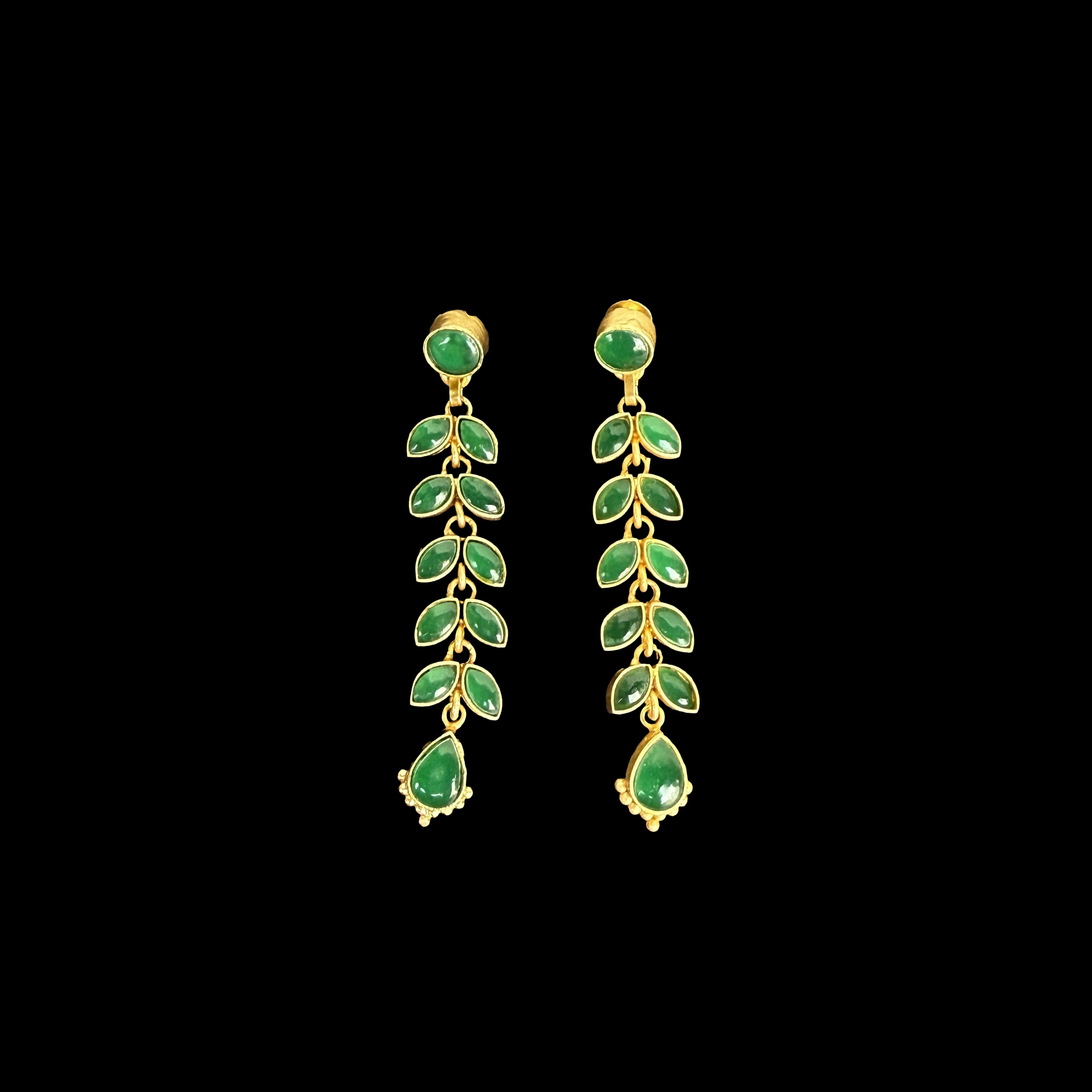 A stunning pair of cascading earrings featuring lush green emerald-like stones set in a delicate gold-tone vine design