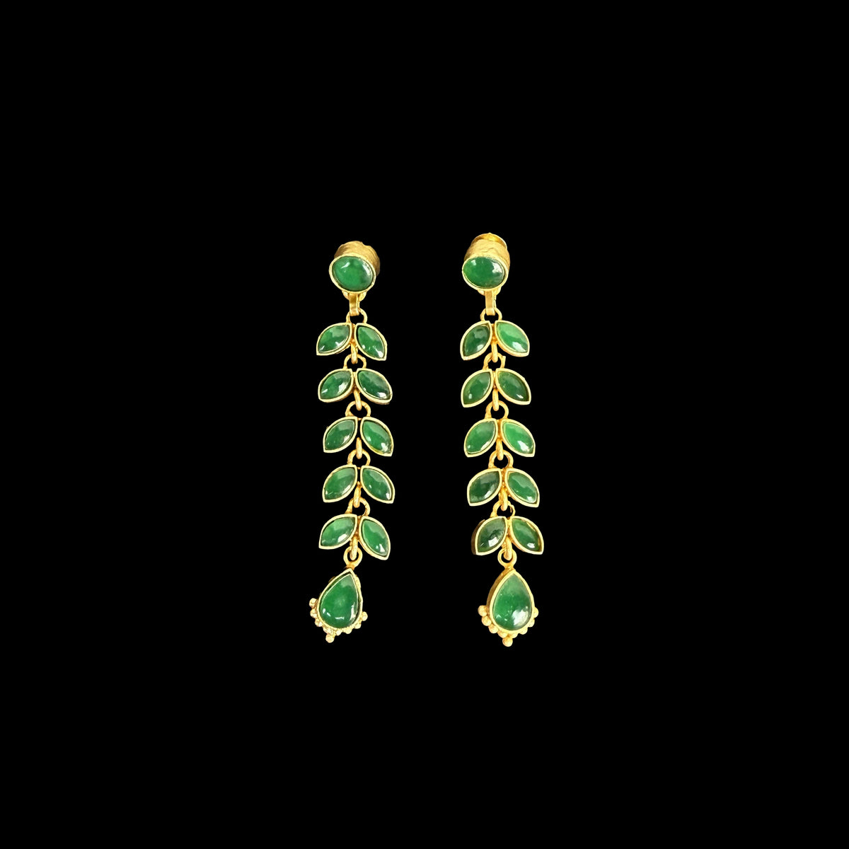 A stunning pair of cascading earrings featuring lush green emerald-like stones set in a delicate gold-tone vine design