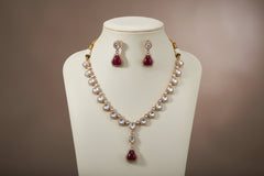 Jewelry set with necklace and earrings on a brown fabric background